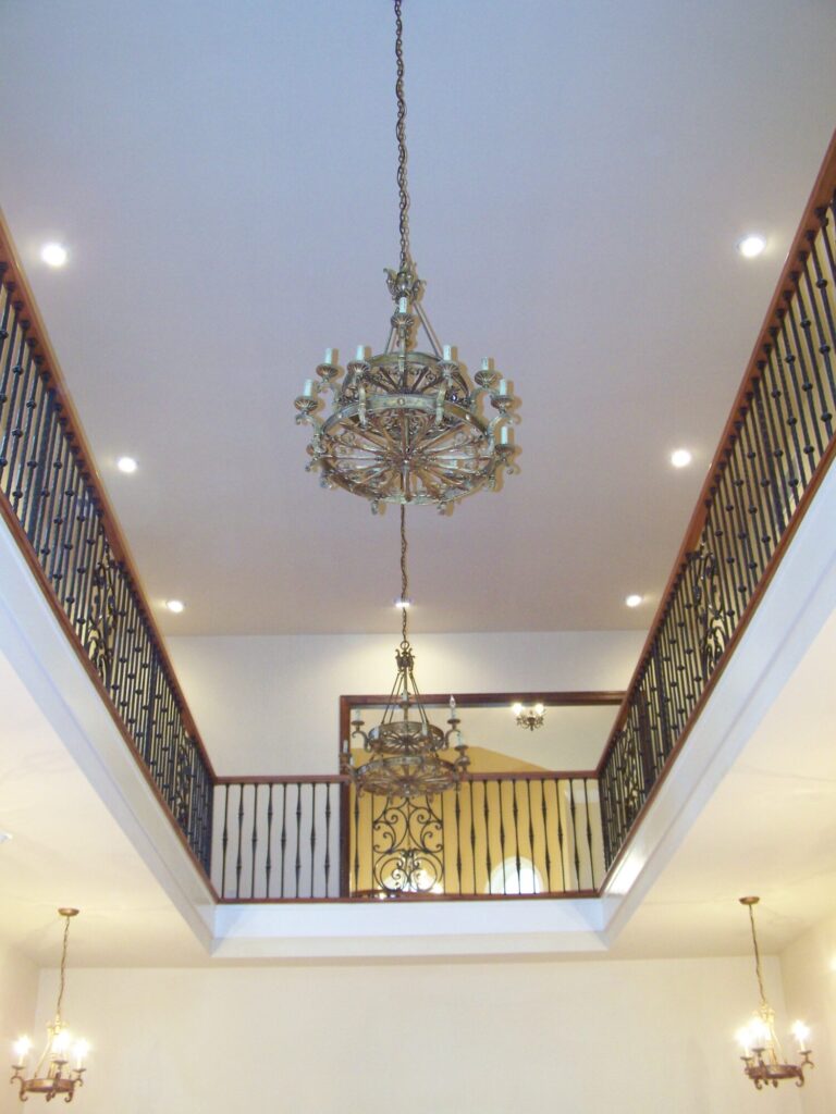 Traditional curved multi level staircase with iron balustrade: Brazilian cherry treads and handrails with tuscany iron. CNC tangent handrails, photo 12 of 18