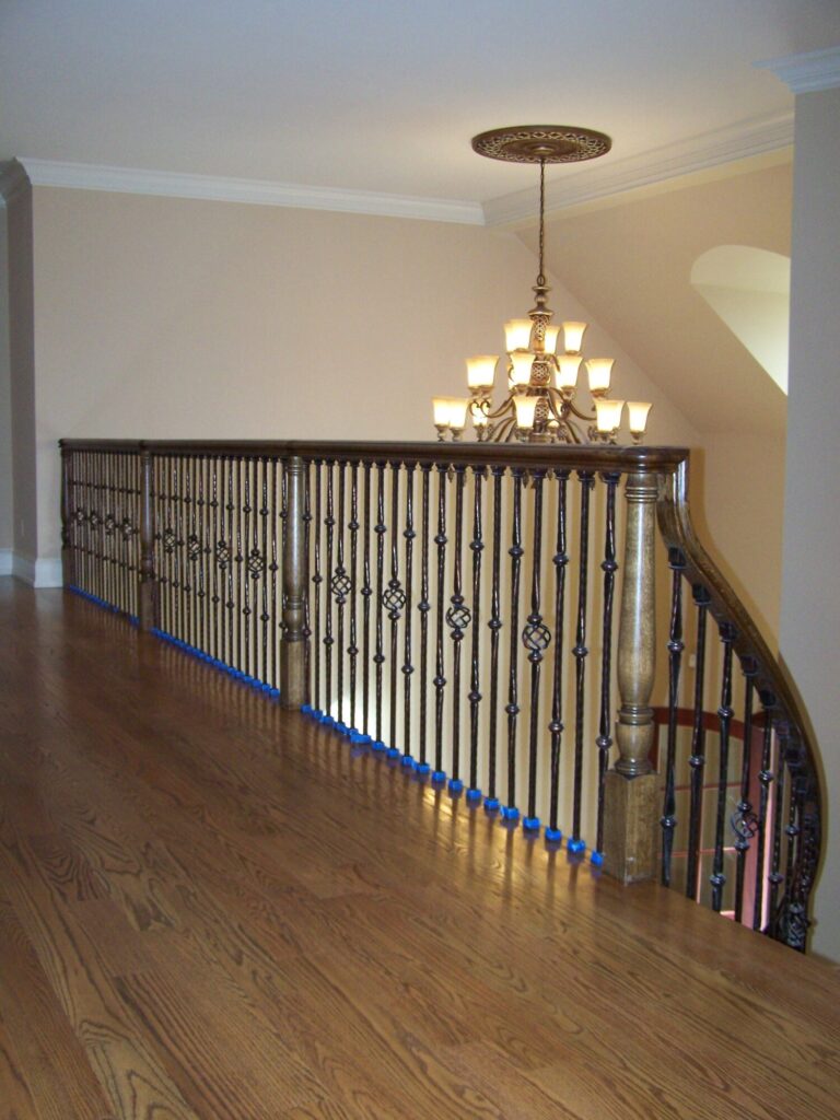 Traditional curved staircase with iron balustrade: Red oak treads and handrail, photo 1 of 11