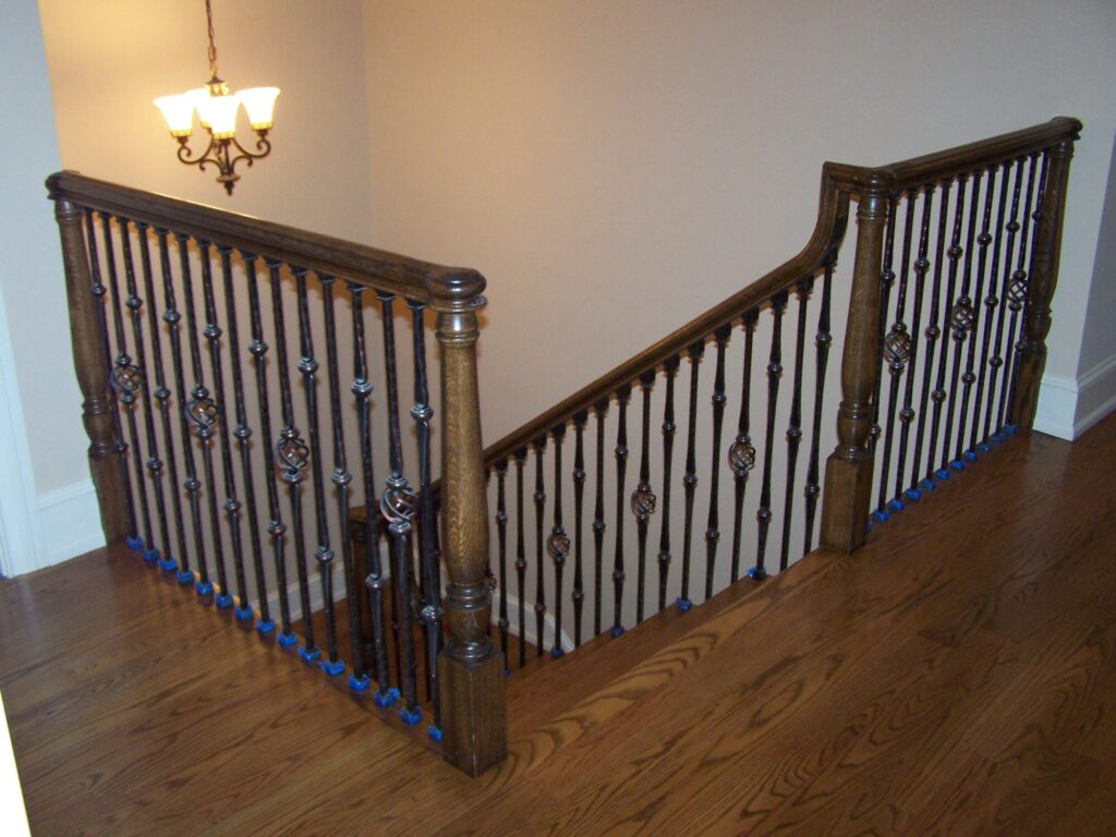 Traditional curved staircase with iron balustrade: Red oak treads and handrail, photo 10 of 11