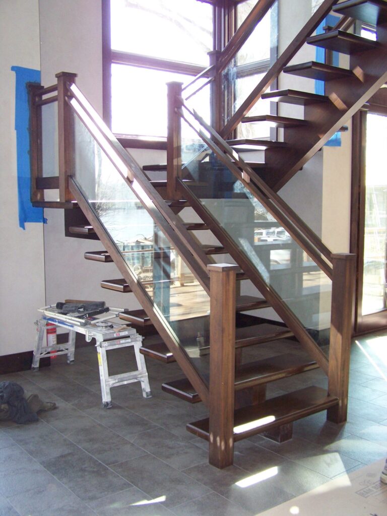 Modern solid walnut staircase with glass panel infill, photo 1 of 10