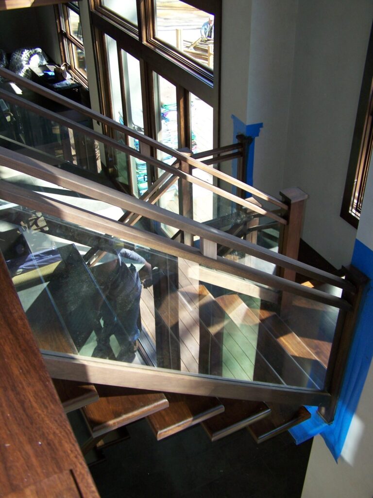 Modern solid walnut staircase with glass panel infill, photo 9 of 10