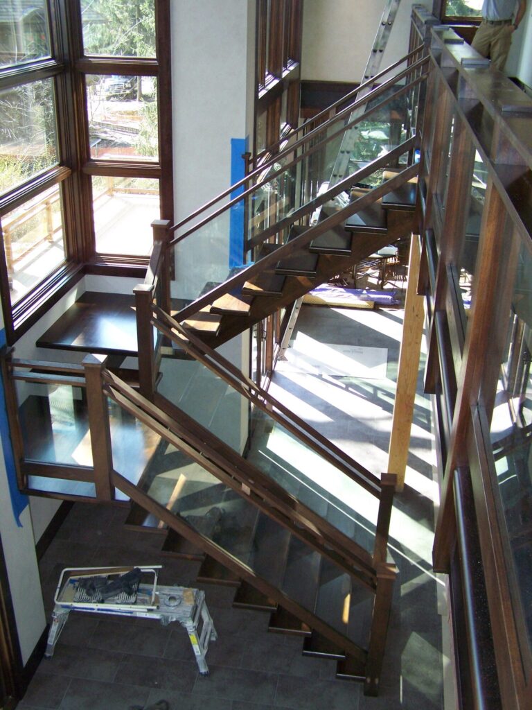 Modern solid walnut staircase with glass panel infill, photo 8 of 10