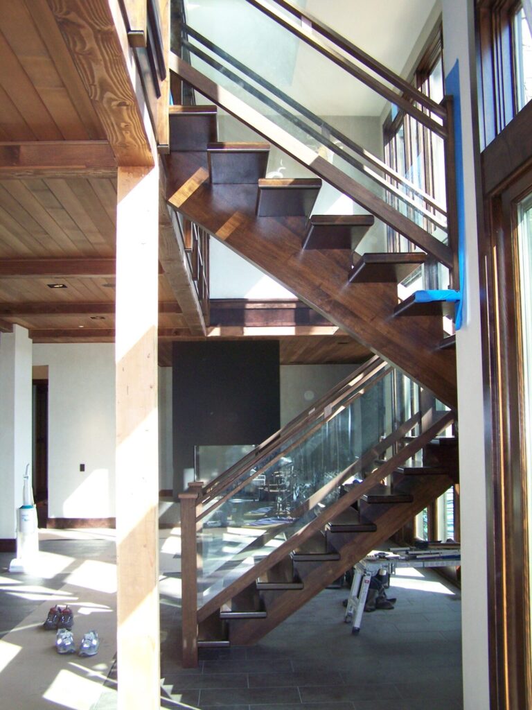 Modern solid walnut staircase with glass panel infill, photo 7 of 10