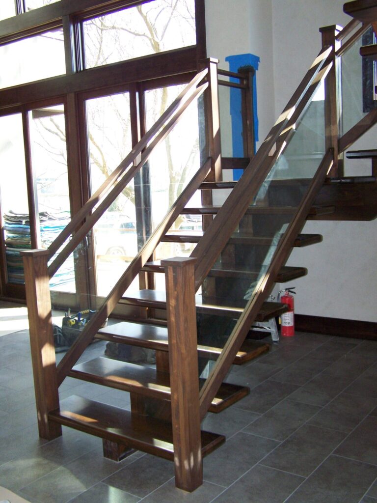 Modern solid walnut staircase with glass panel infill, photo 6 of 10