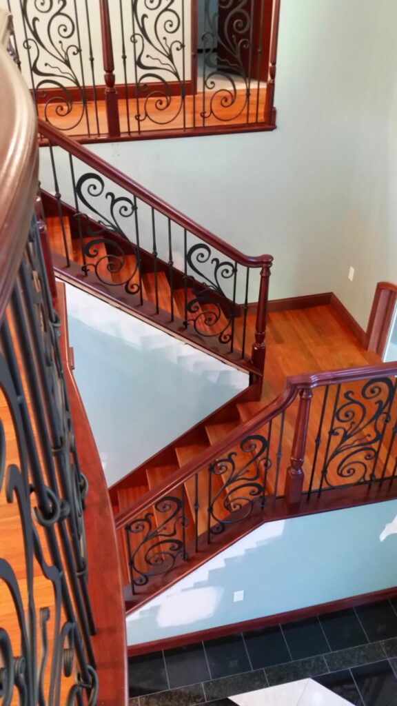 Traditional iron scroll infill with wood newel and handrails, photo 10 of 14