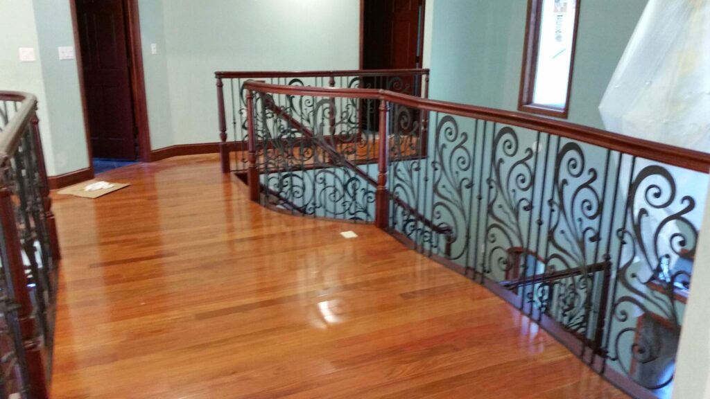 Traditional iron scroll infill with wood newel and handrails, photo 12 of 14