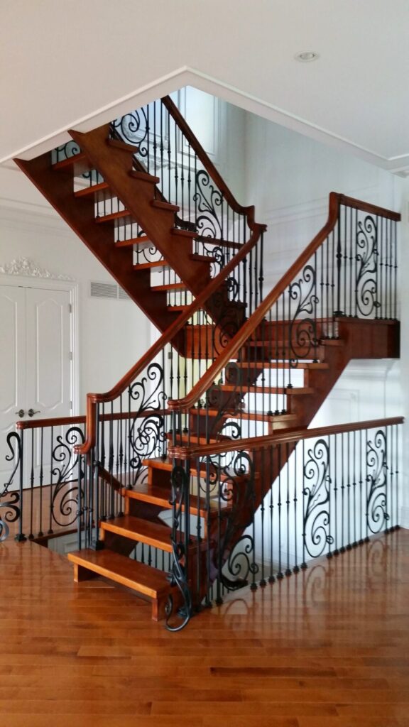 Modern open rise stair with vertical and scrolled balustrade: Solid maple stair and rail with iron balustrade, photo 1 of 21