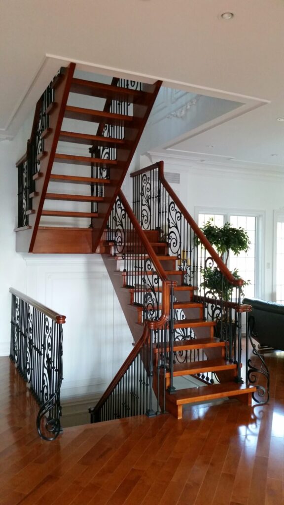 Modern open rise stair with vertical and scrolled balustrade: Solid maple stair and rail with iron balustrade, photo 2 of 21