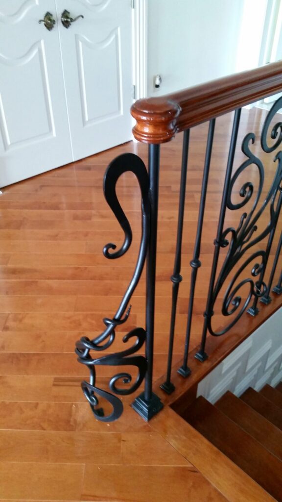 Modern open rise stair with vertical and scrolled balustrade: Solid maple stair and rail with iron balustrade, photo 3 of 21