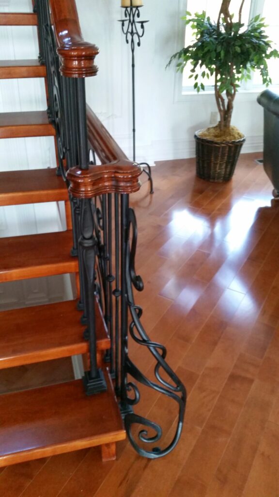 Modern open rise stair with vertical and scrolled balustrade: Solid maple stair and rail with iron balustrade, photo 4 of 21