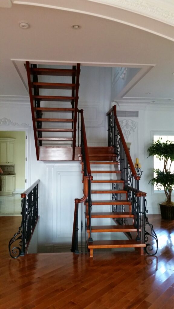 Modern open rise stair with vertical and scrolled balustrade: Solid maple stair and rail with iron balustrade, photo 5 of 21