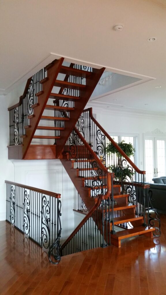 Modern open rise stair with vertical and scrolled balustrade: Solid maple stair and rail with iron balustrade, photo 21 of 21