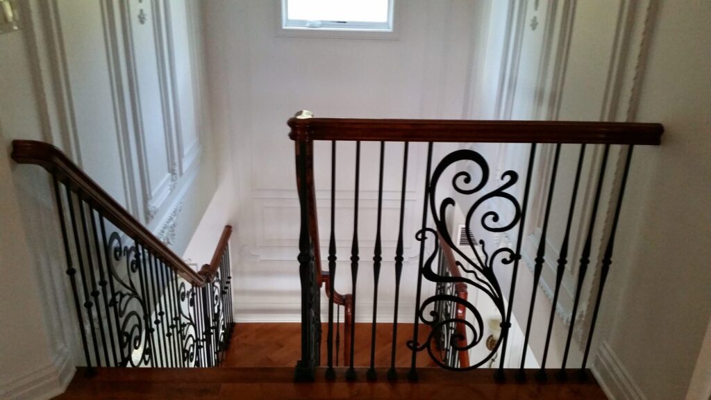 Modern open rise stair with vertical and scrolled balustrade: Solid maple stair and rail with iron balustrade, photo 8 of 21