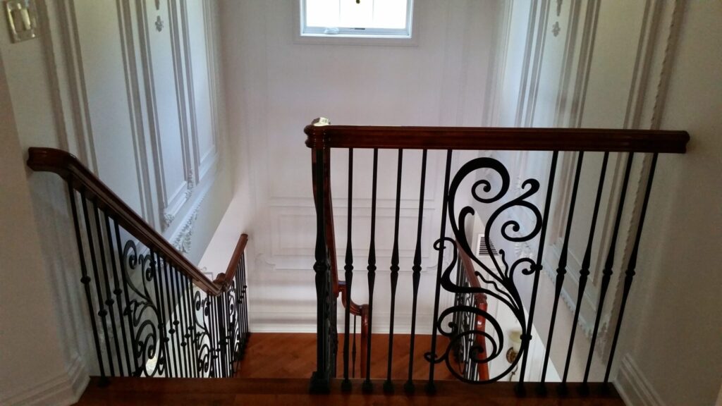 Modern open rise stair with vertical and scrolled balustrade: Solid maple stair and rail with iron balustrade, photo 9 of 21