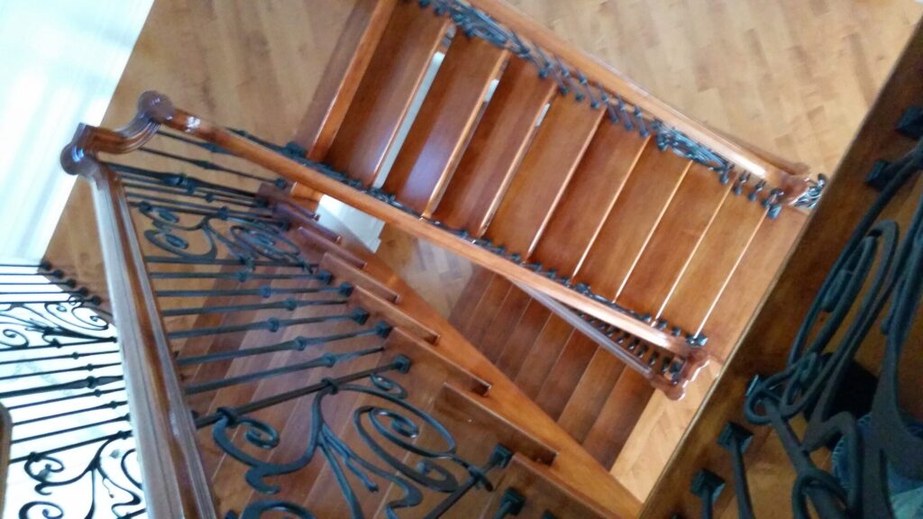 Modern open rise stair with vertical and scrolled balustrade: Solid maple stair and rail with iron balustrade, photo 10 of 21