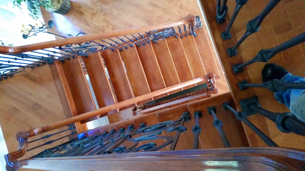 Modern open rise stair with vertical and scrolled balustrade: Solid maple stair and rail with iron balustrade, photo 11 of 21