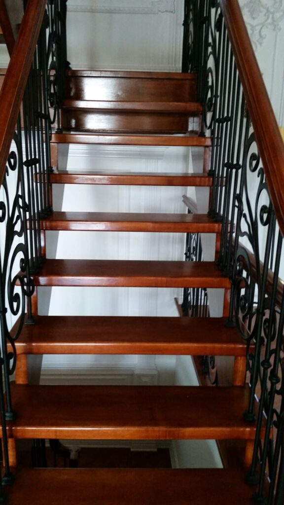 Modern open rise stair with vertical and scrolled balustrade: Solid maple stair and rail with iron balustrade, photo 13 of 21