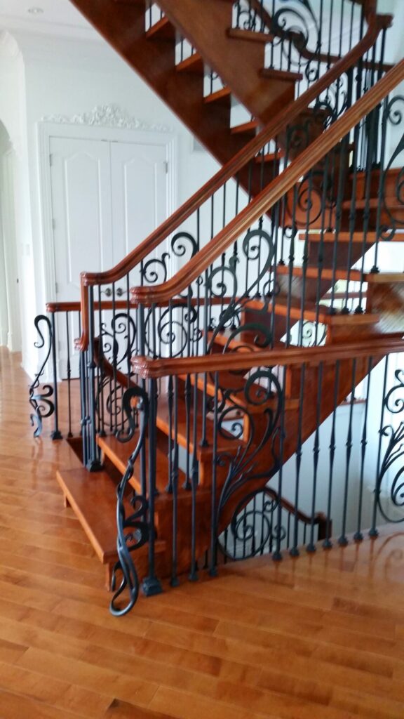 Modern open rise stair with vertical and scrolled balustrade: Solid maple stair and rail with iron balustrade, photo 14 of 21