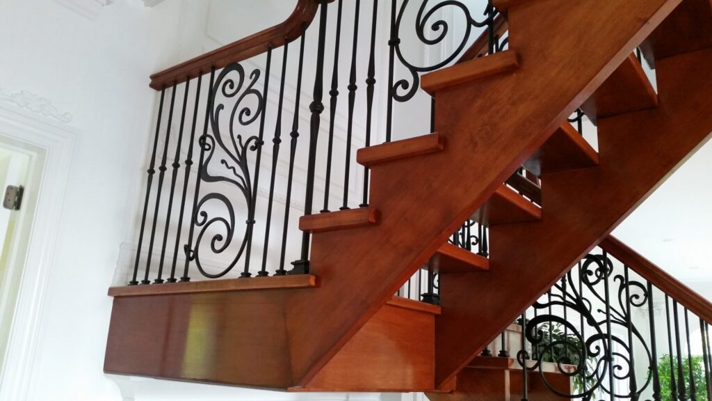 Modern open rise stair with vertical and scrolled balustrade: Solid maple stair and rail with iron balustrade, photo 18 of 21
