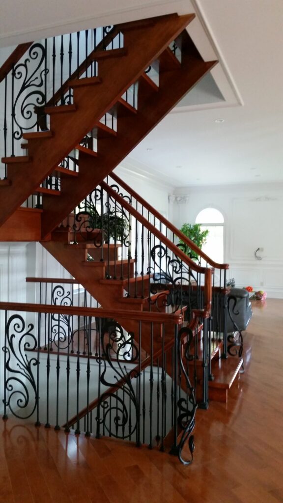 Modern open rise stair with vertical and scrolled balustrade: Solid maple stair and rail with iron balustrade, photo 20 of 21