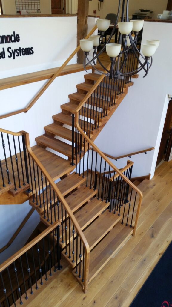 Rustic modern staircase with thick treads and hammered iron balusters: White oak treads with open risers, photo 9 of 10