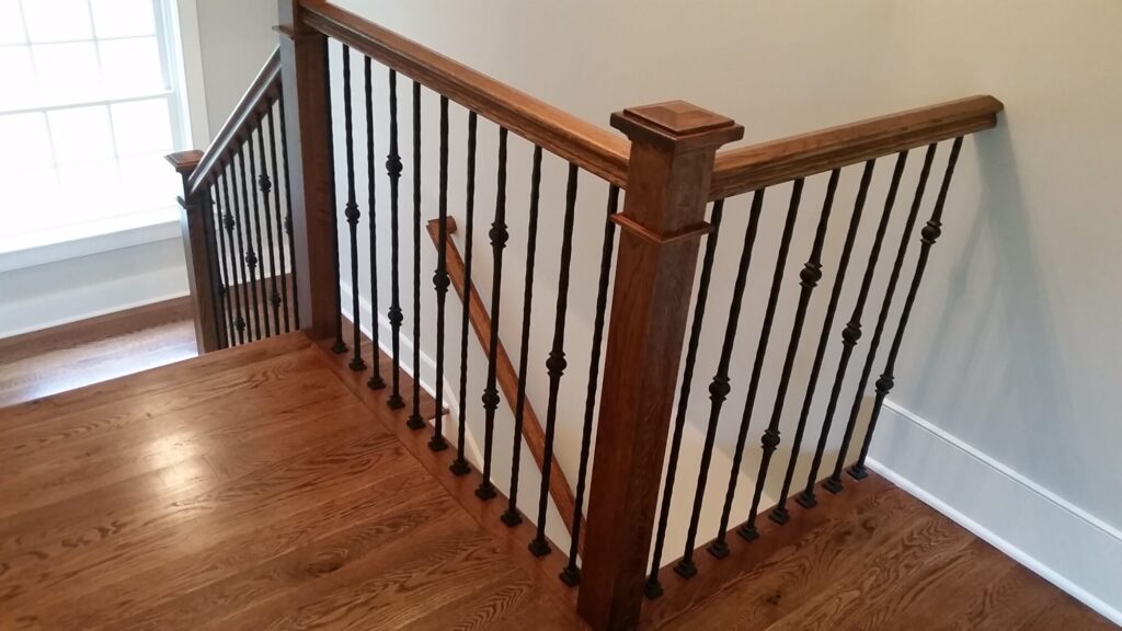 White oak square newel with simple cap and neck detail: Hammered rustic iron balustrade. Upper Makefield, PA, photo 4 of 17
