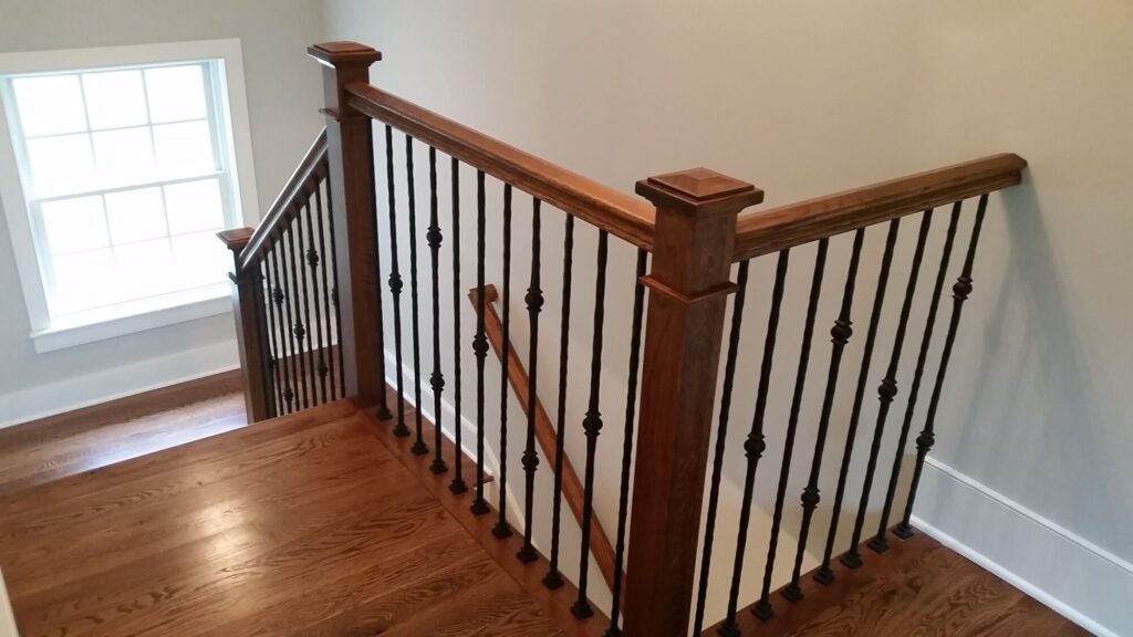 White oak square newel with simple cap and neck detail: Hammered rustic iron balustrade. Upper Makefield, PA, photo 5 of 17
