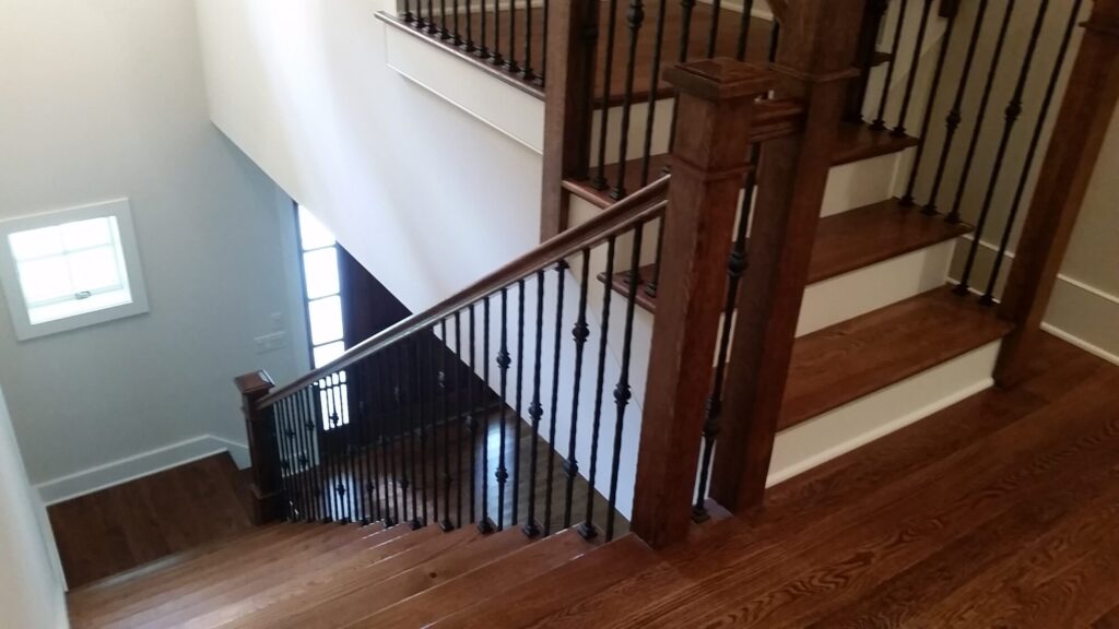 White oak square newel with simple cap and neck detail: Hammered rustic iron balustrade. Upper Makefield, PA, photo 6 of 17