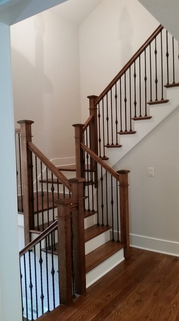 White oak square newel with simple cap and neck detail: Hammered rustic iron balustrade. Upper Makefield, PA, photo 7 of 17