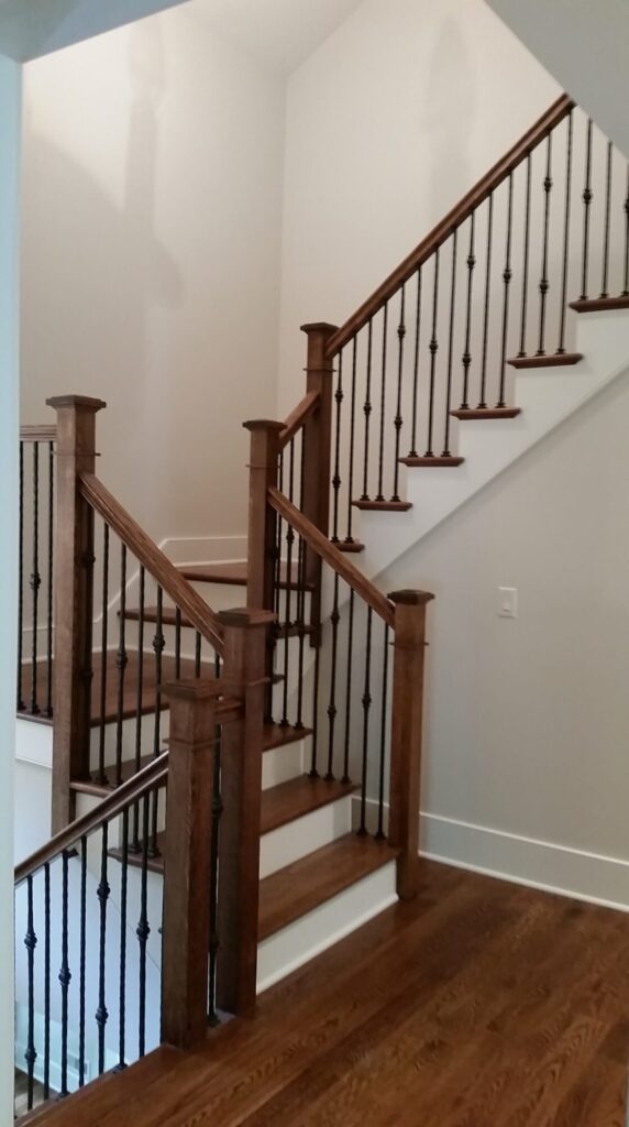 White oak square newel with simple cap and neck detail: Hammered rustic iron balustrade. Upper Makefield, PA, photo 8 of 17