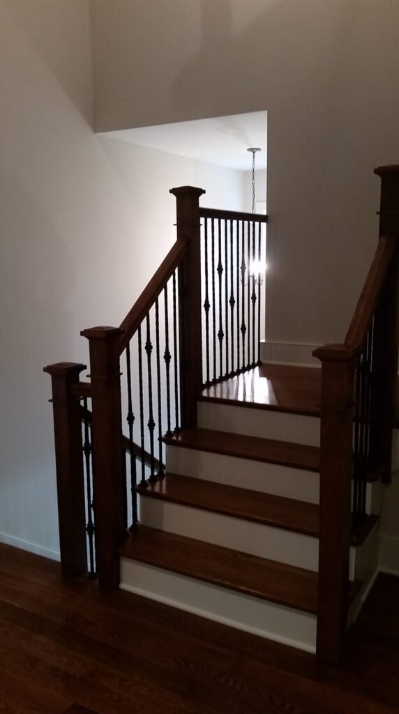 White oak square newel with simple cap and neck detail: Hammered rustic iron balustrade. Upper Makefield, PA, photo 9 of 17