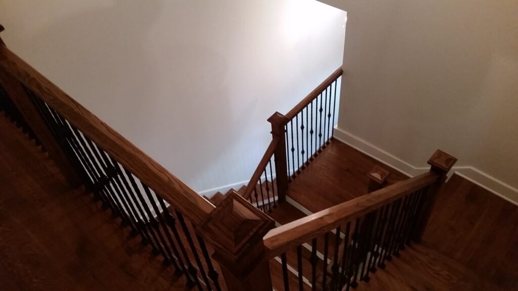 White oak square newel with simple cap and neck detail: Hammered rustic iron balustrade. Upper Makefield, PA, photo 11 of 17