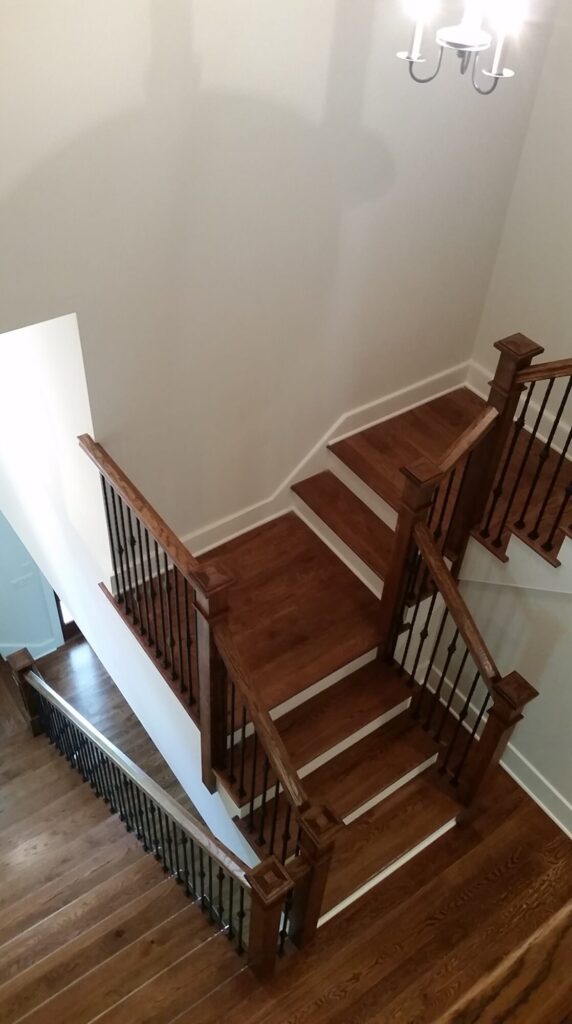 White oak square newel with simple cap and neck detail: Hammered rustic iron balustrade. Upper Makefield, PA, photo 12 of 17