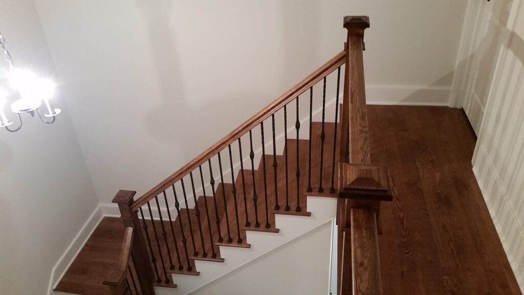 White oak square newel with simple cap and neck detail: Hammered rustic iron balustrade. Upper Makefield, PA, photo 14 of 17