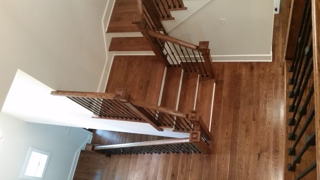 White oak square newel with simple cap and neck detail: Hammered rustic iron balustrade. Upper Makefield, PA, photo 15 of 17
