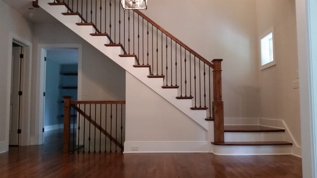 White oak square newel with simple cap and neck detail: Hammered rustic iron balustrade. Upper Makefield, PA, photo 17 of 17