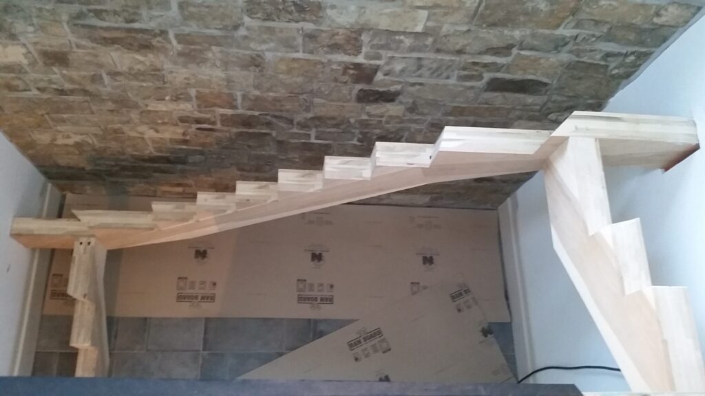 Solid hickory center stringer stair with hammered iron balusters. Carversville PA, photo 4 of 9