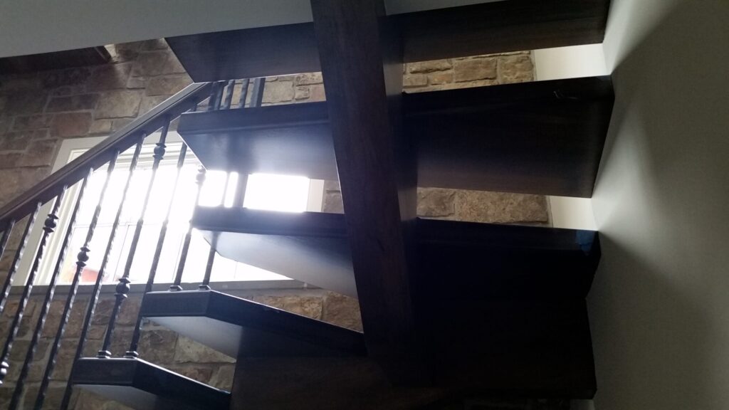 Solid hickory center stringer stair with hammered iron balusters. Carversville PA, photo 9 of 9