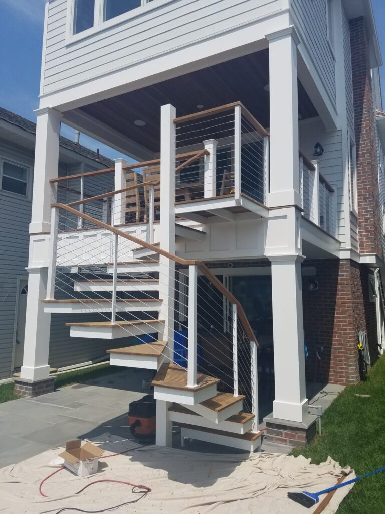 Aluminum square spiral in white with ipe treads and cable rail: Ocean City NJ, photo 2 of 11