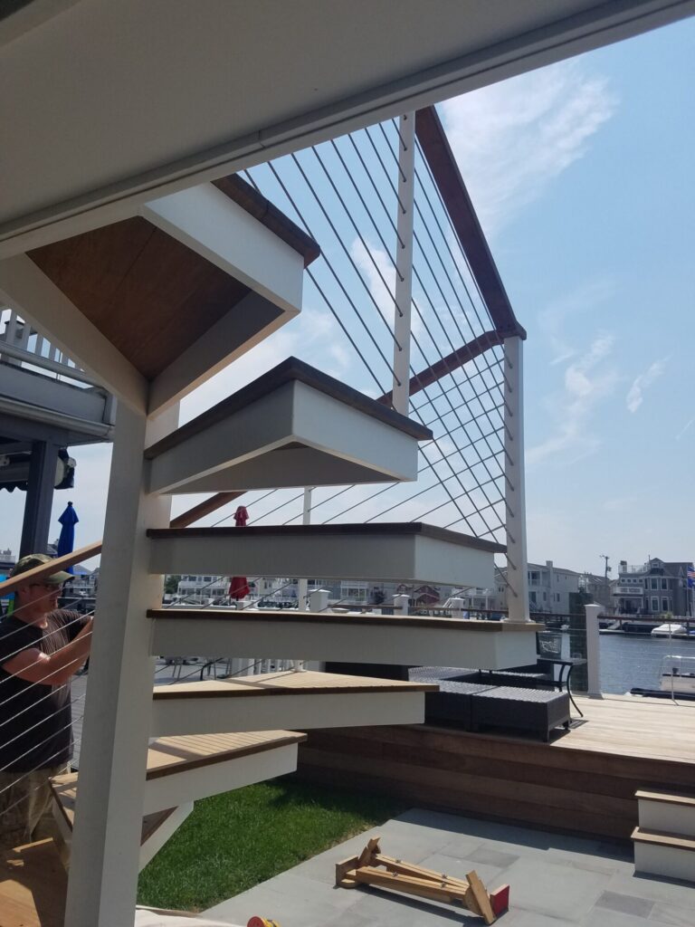 Aluminum square spiral in white with ipe treads and cable rail: Ocean City NJ, photo 5 of 11
