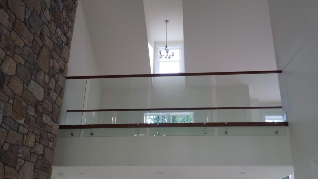 Center stringer stair with 3" thick treads, glass panels with wood top rail, photo 3 of 17