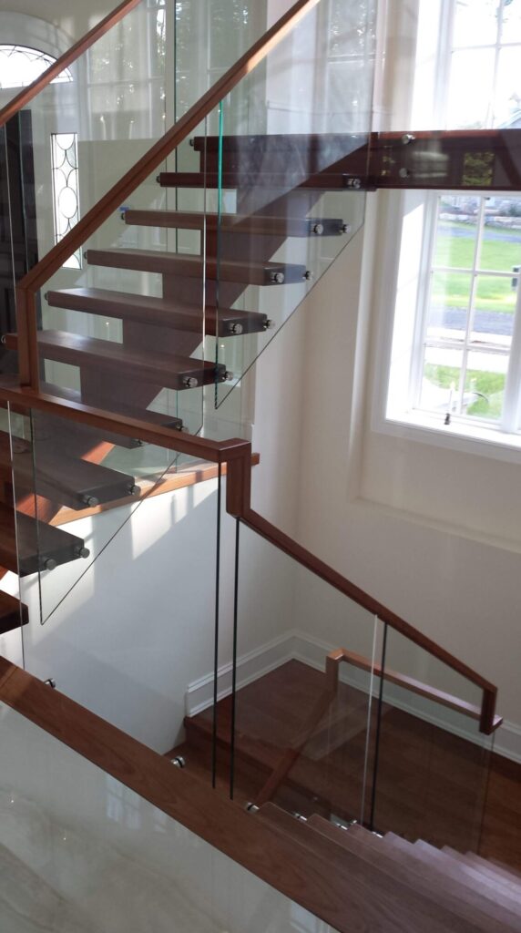 Center stringer stair with 3" thick treads, glass panels with wood top rail, photo 4 of 17