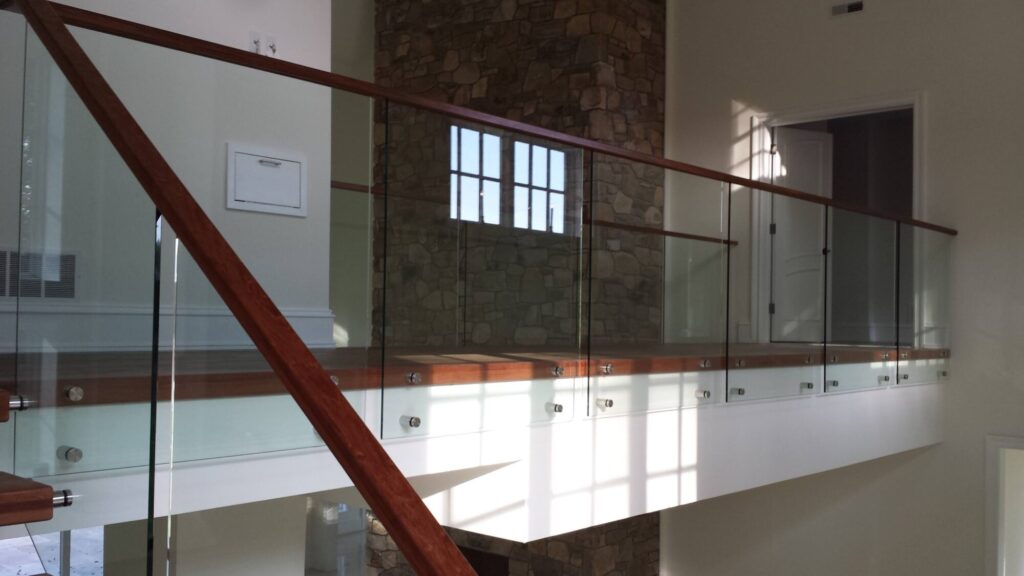 Center stringer stair with 3" thick treads, glass panels with wood top rail, photo 5 of 17