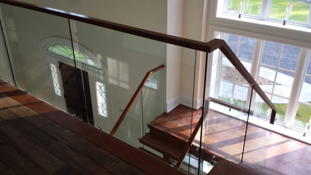 Center stringer stair with 3" thick treads, glass panels with wood top rail, photo 6 of 17