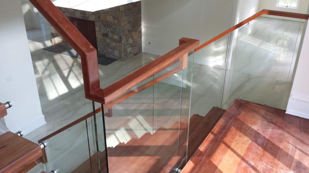 Center stringer stair with 3" thick treads, glass panels with wood top rail, photo 9 of 17