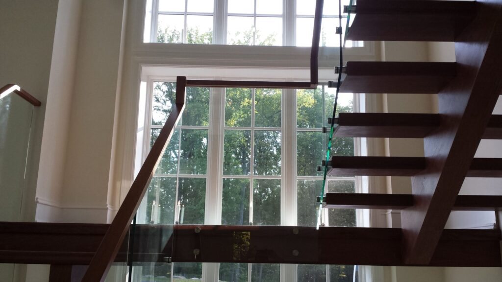 Center stringer stair with 3" thick treads, glass panels with wood top rail, photo 10 of 17