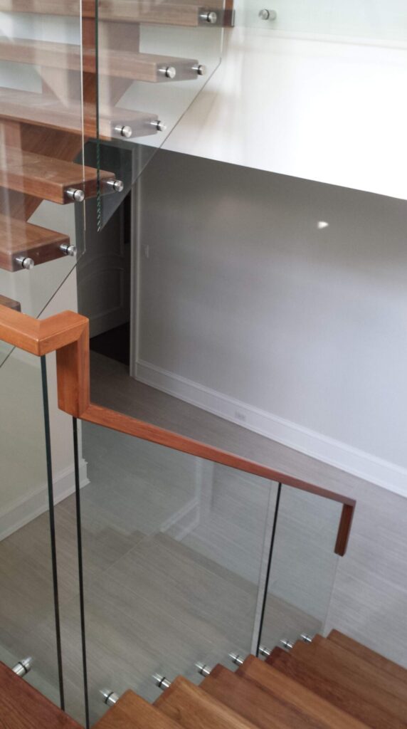 Center stringer stair with 3" thick treads, glass panels with wood top rail, photo 11 of 17