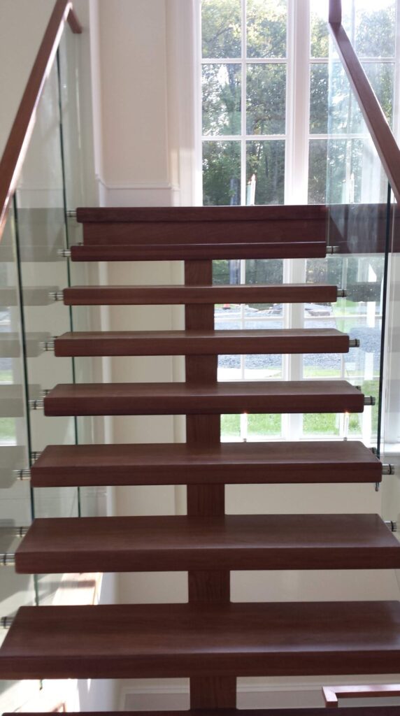 Center stringer stair with 3" thick treads, glass panels with wood top rail, photo 17 of 17
