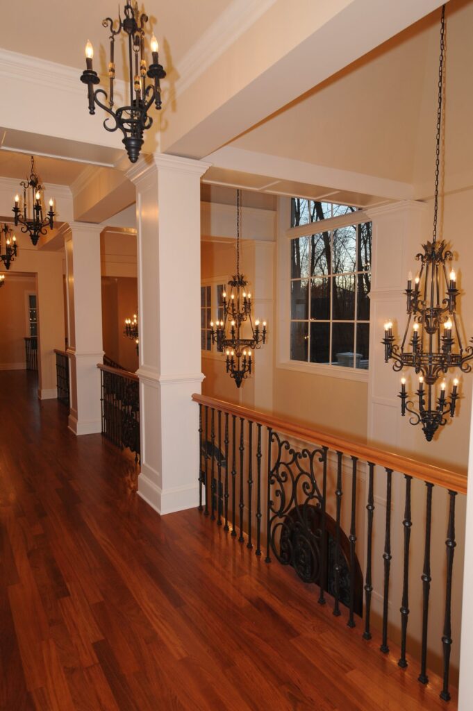Traditional curved multi level staircase with iron balustrade: Brazilian cherry treads and handrails with tuscany iron. CNC tangent handrails, photo 3 of 18