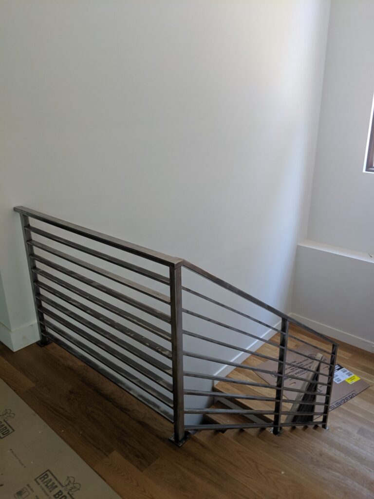 Mono stringer stair with horizontal clear coated metal rails, photo 3 of 6